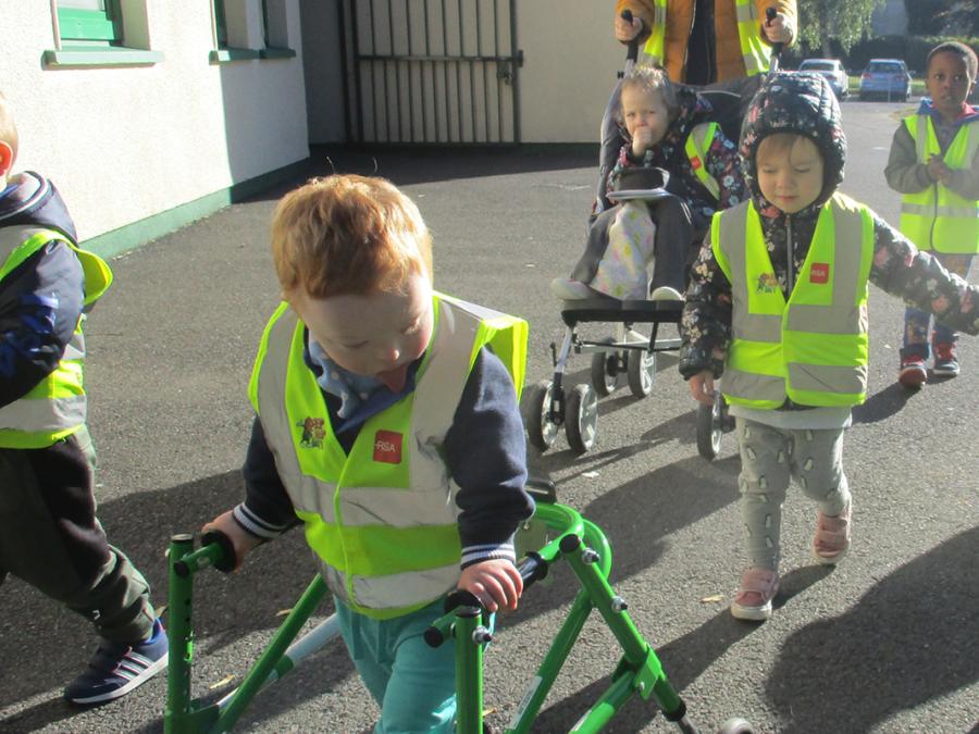 A child using a rollator on an outdoor path, Graiguecullen Parish Childcare Centre, Graiguecullen, County Laois.