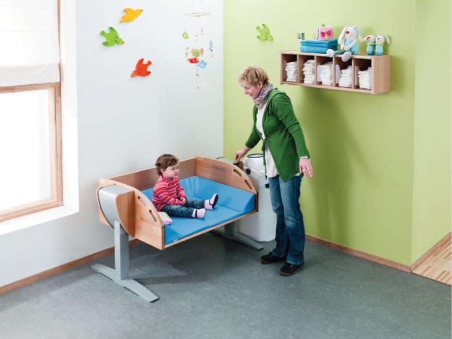 Power operated height adjustable changing table